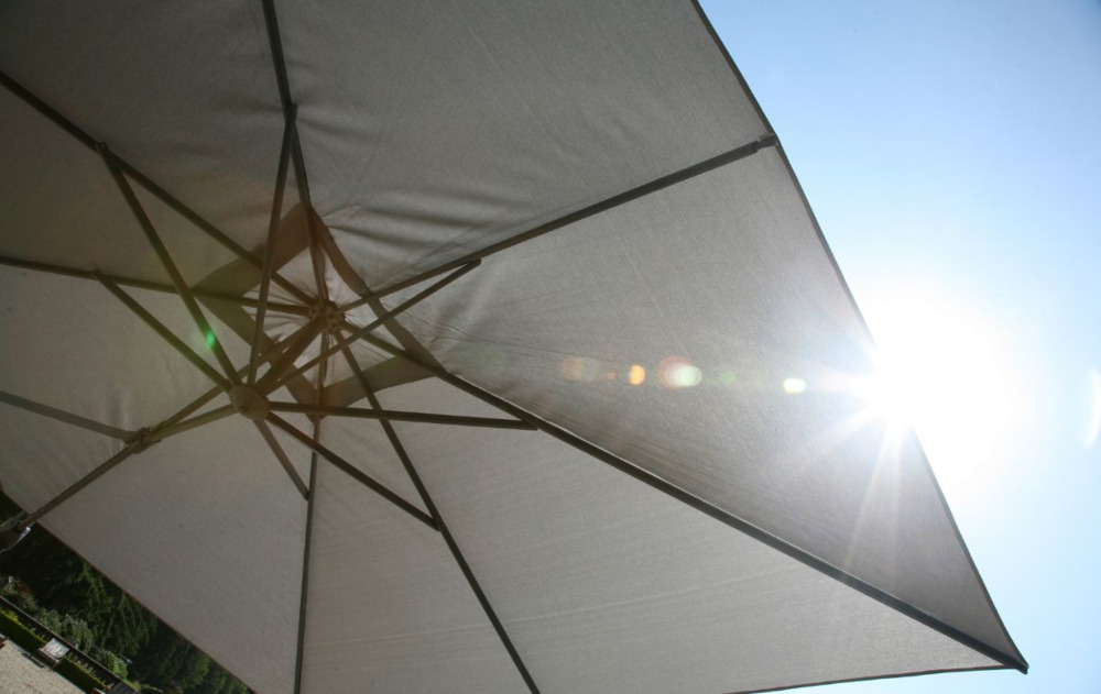 Grey cantilever parasol in the sun