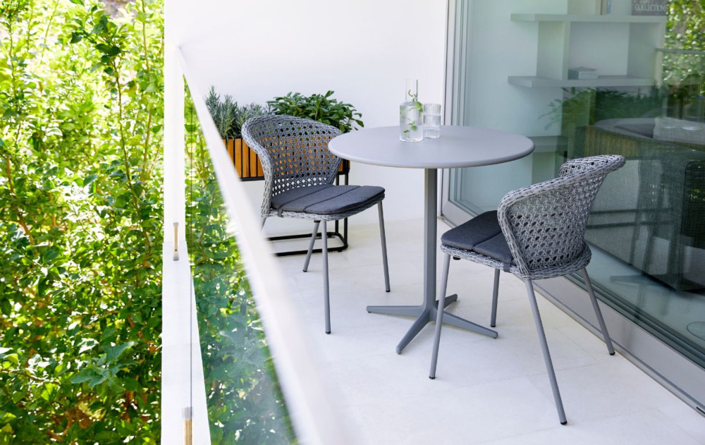 Grey rattan bistro set on a small balcony