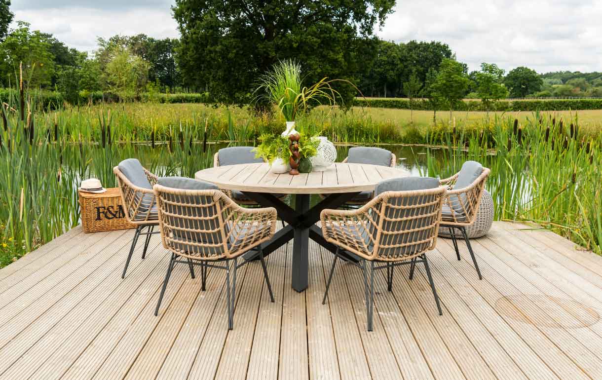 Cottage rattan dining chairs with round teak dining table