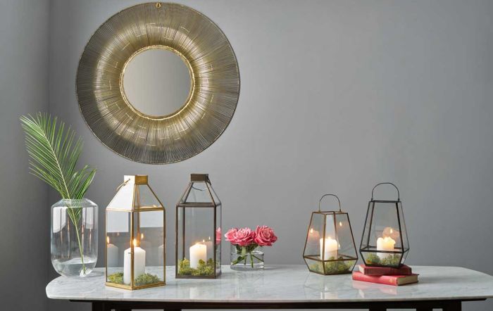 Gold wire wall mirror and metal lanterns
