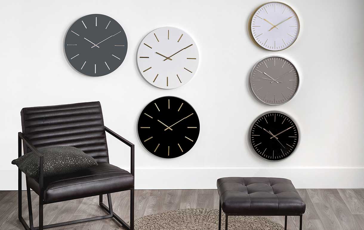 Monochrome wall clocks and leather accent chair