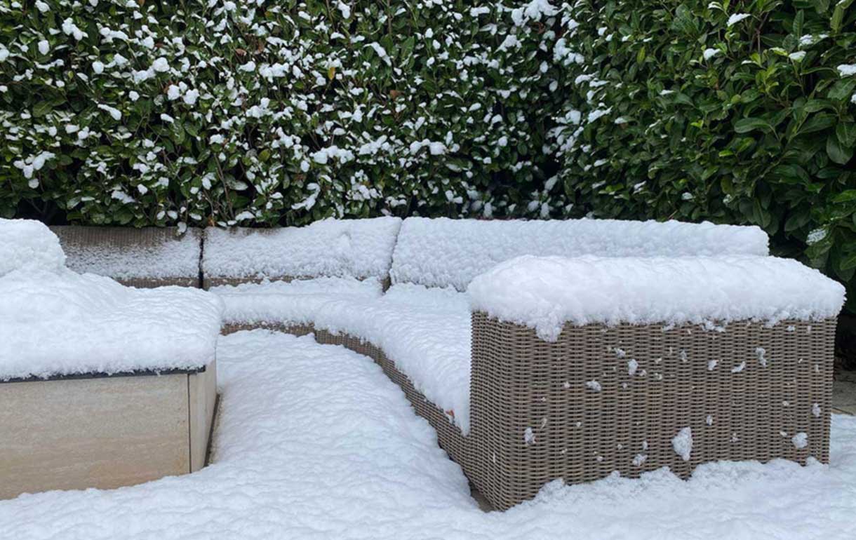 Rattan garden sofa in the snow