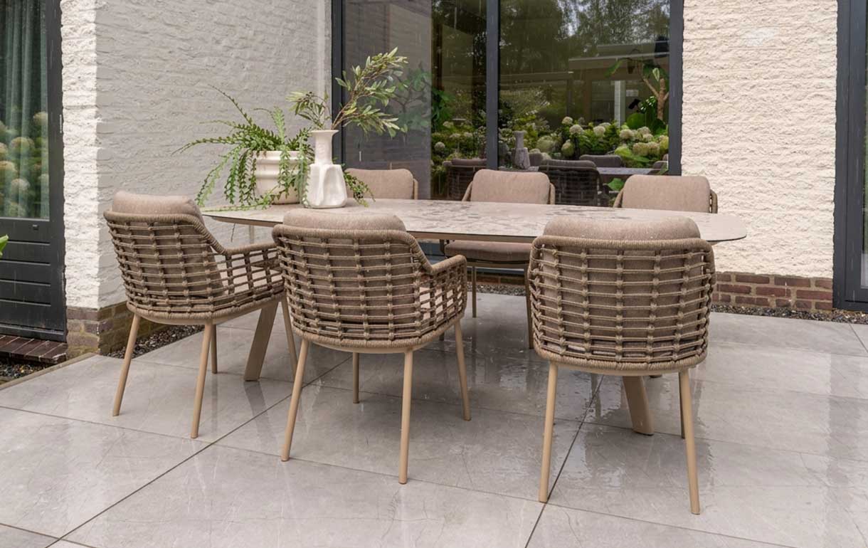 Oval garden dining table during a light shower