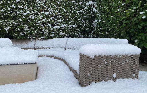 Rattan garden sofa in the snow